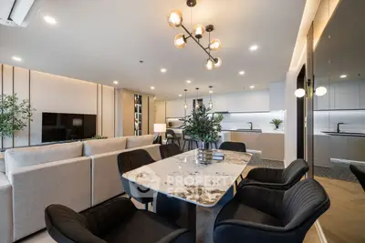 Luxurious open-plan living and dining area with modern kitchen and elegant lighting.