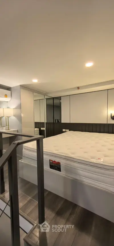 Modern bedroom with sleek design and cozy ambiance, featuring a comfortable bed and stylish decor.