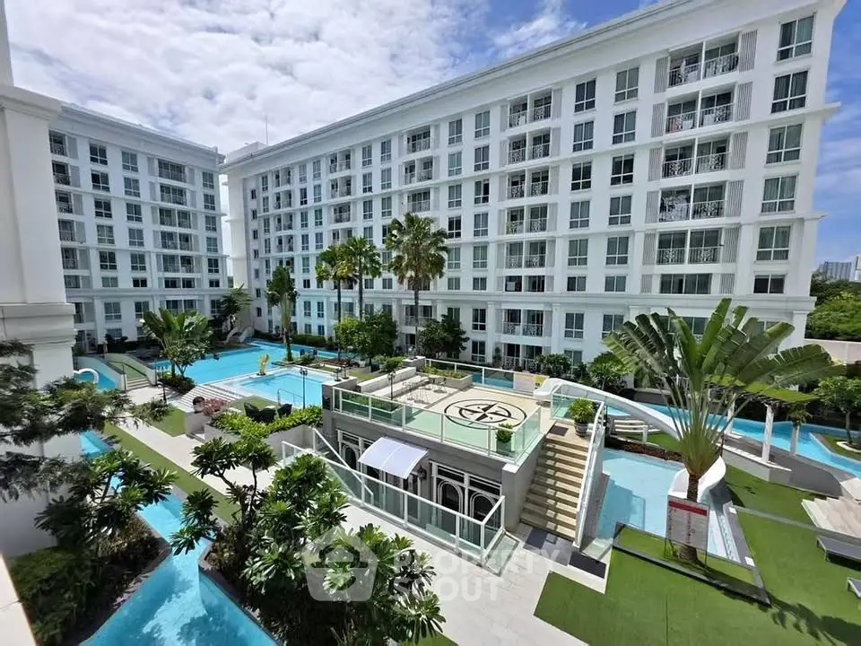 Luxurious condominium with stunning pool and lush greenery, perfect for modern living.