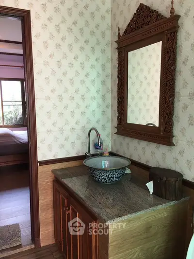 Charming bathroom with ornate mirror and stylish sink in cozy home