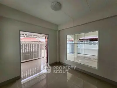 Spacious interior with large window and balcony access in modern home