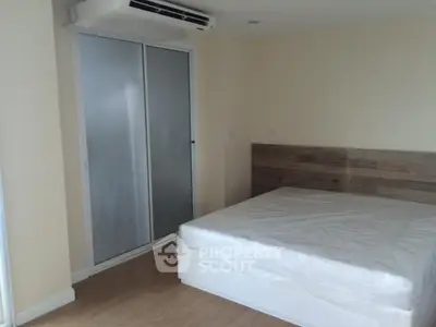 Modern bedroom with minimalist design and air conditioning unit