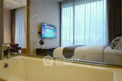Luxurious bedroom with modern decor and bathtub, featuring a large window with city view.
