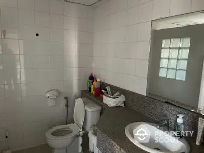 Modern bathroom with sleek fixtures and ample counter space in a stylish home.