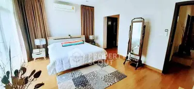 Spacious bedroom with modern decor and natural light