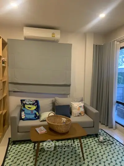 Cozy living room with modern sofa, air conditioning, and stylish decor