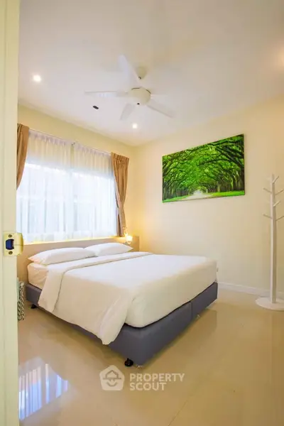 Bright and cozy bedroom with modern decor and large window