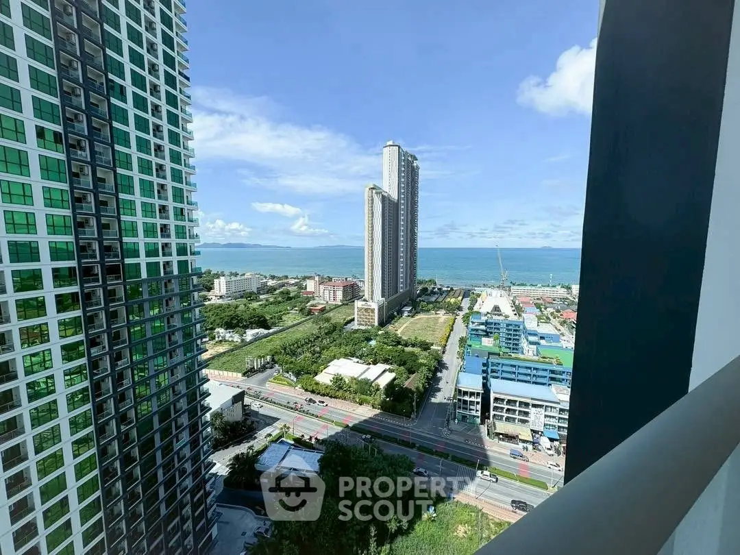 Stunning high-rise city view with ocean backdrop from a modern balcony