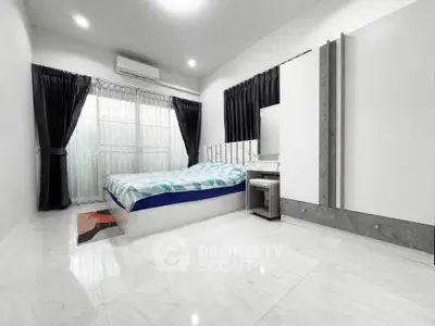 Spacious modern bedroom with sleek design and ample natural light