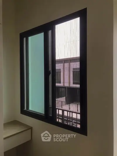 Modern window with a view of neighboring building, perfect for natural light.