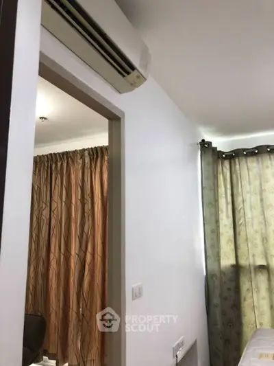 Cozy bedroom with air conditioning and elegant curtains