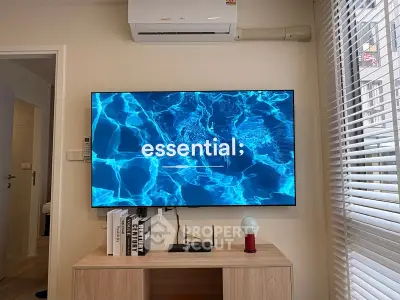 Modern living room with wall-mounted TV and air conditioning unit, showcasing stylish decor and natural light.