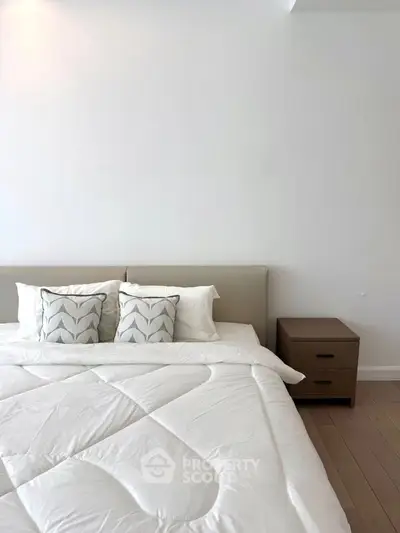 Elegant bedroom with modern design and cozy bedding, perfect for relaxation.