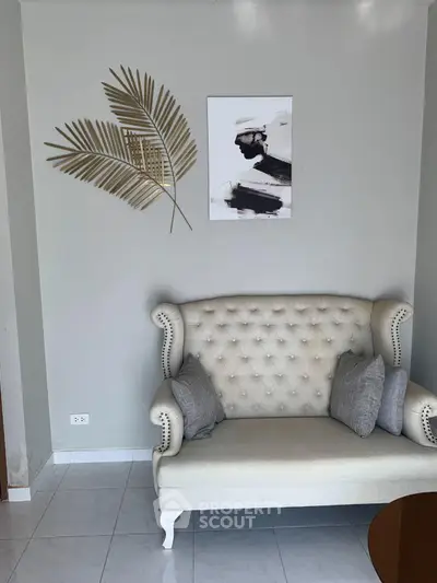 Elegant living room with stylish sofa and modern wall art, perfect for cozy relaxation.