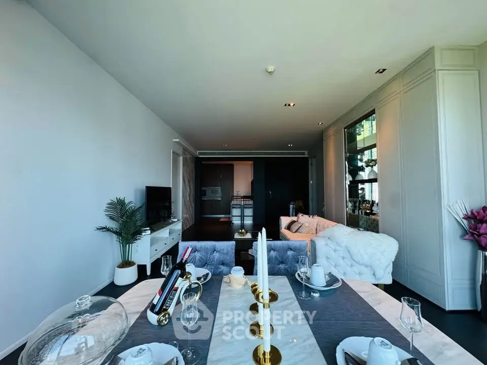 Luxurious open-plan living room with elegant dining setup and modern decor