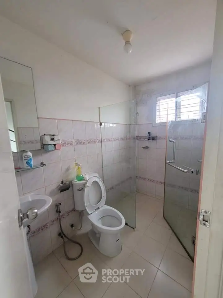 Compact bathroom with glass shower enclosure and modern fixtures