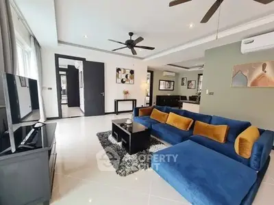 Spacious living room with modern decor and plush blue sofa