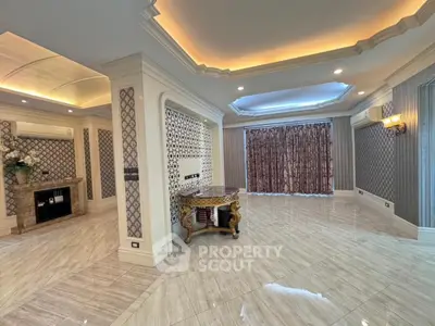 Luxurious living room with elegant ceiling design and marble flooring