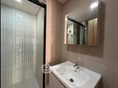 Modern bathroom with sleek shower and stylish sink in contemporary design.