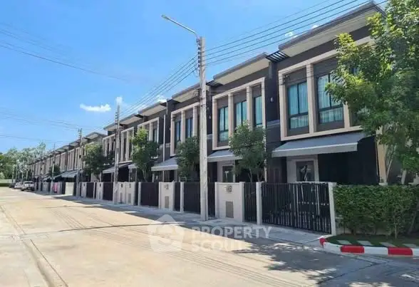 Modern townhouse row with sleek design and lush greenery