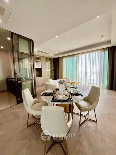 Luxurious dining area with elegant table setting and floor-to-ceiling windows in modern apartment.