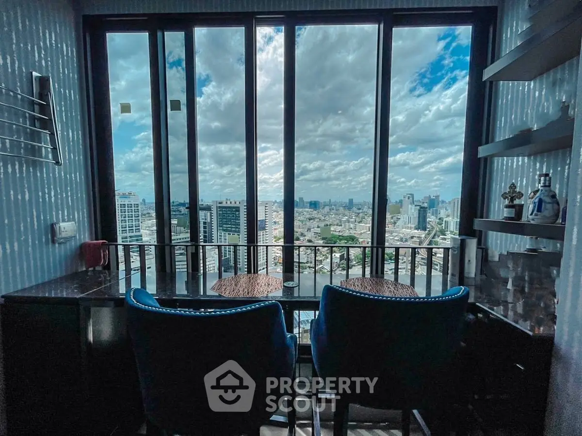 Stunning cityscape view from a modern high-rise balcony with stylish seating.