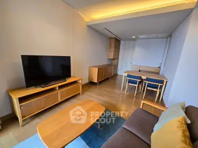 Spacious living room with modern furniture and flat-screen TV, perfect for relaxation and entertainment.