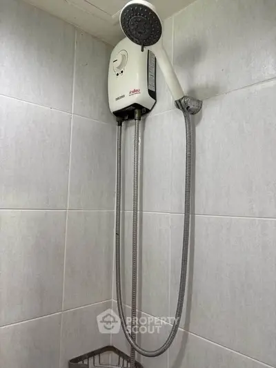 Modern bathroom shower with sleek design and efficient water heater.