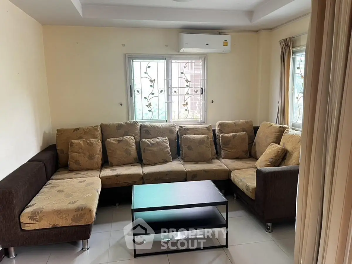 Spacious living room with large sectional sofa and modern coffee table