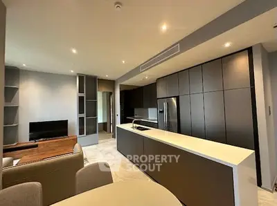 Modern open-layout kitchen and living room with sleek cabinetry and stylish decor.