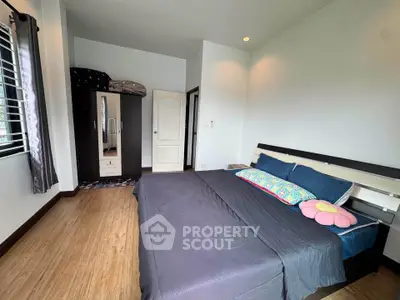 Spacious bedroom with modern decor and ample natural light