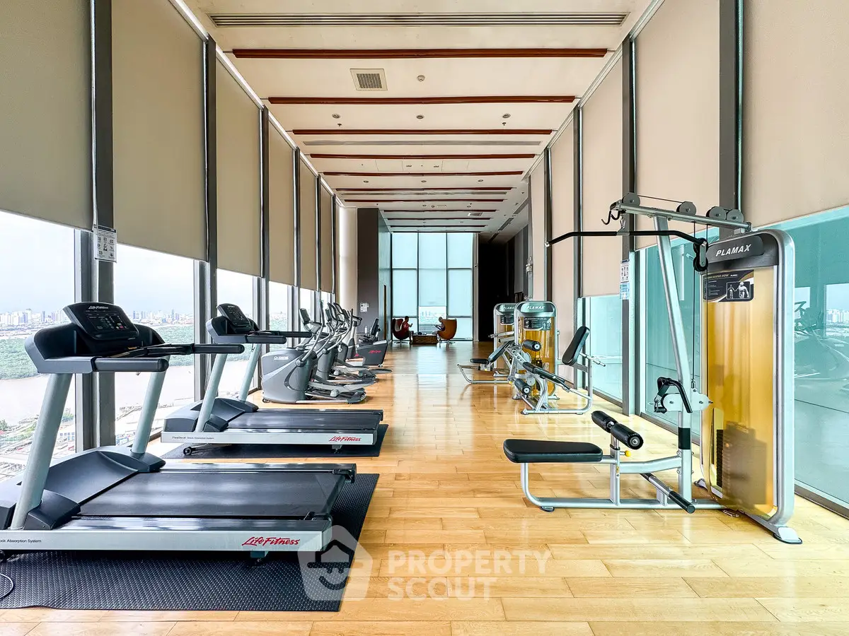 Luxurious high-rise gym with modern fitness equipment and panoramic city views.