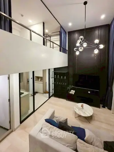 Modern loft-style living room with high ceilings and elegant lighting