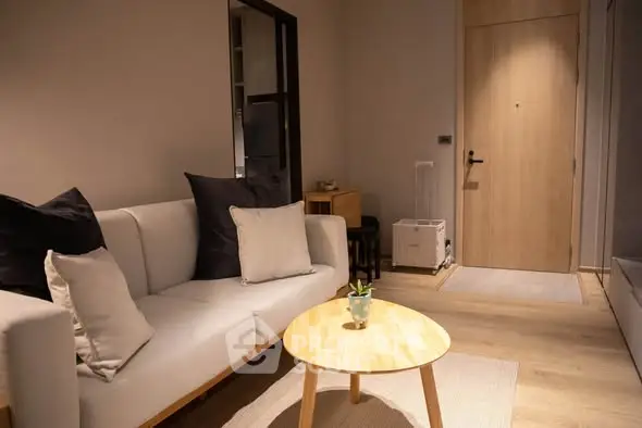 Modern living room with cozy sofa and stylish decor in a contemporary apartment.