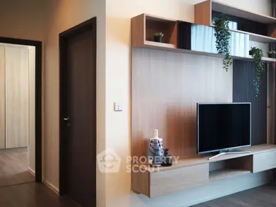Modern living room with stylish wooden TV unit and decorative plants
