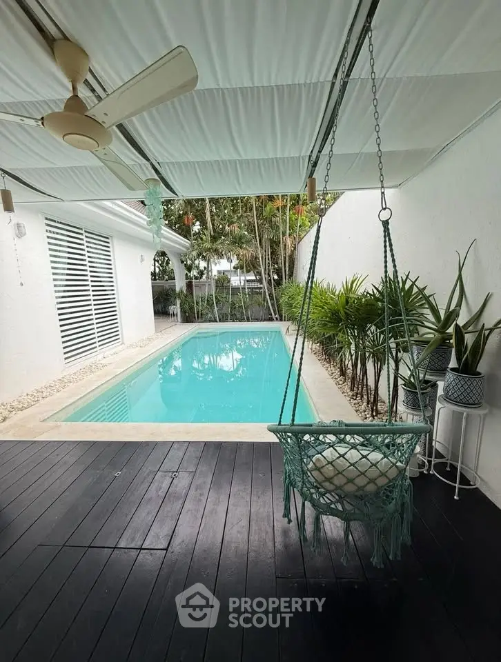 Charming backyard with a private pool and cozy swing chair, perfect for relaxation and outdoor enjoyment.