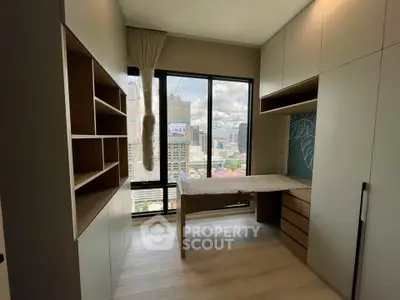 Modern study room with city view, built-in shelves, and ample natural light.