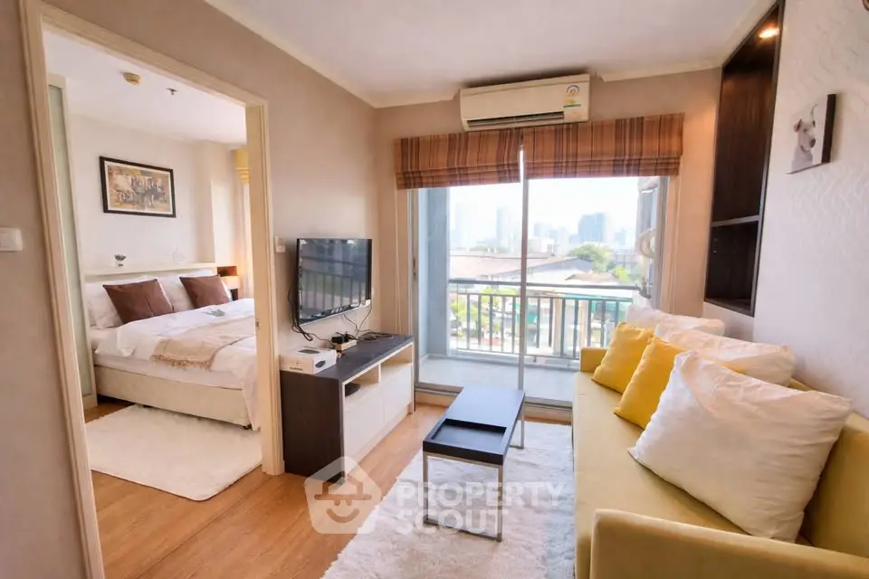 Charming living room with balcony view in modern apartment, featuring cozy seating and natural light.