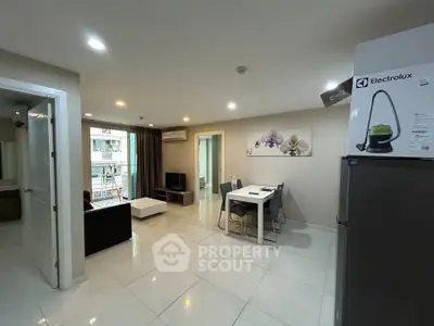 Spacious modern living room with dining area and balcony access in a stylish apartment.