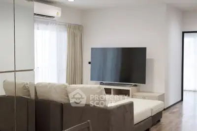 Modern living room with large TV and comfortable sofa in a bright apartment