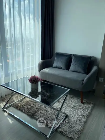 Chic living room with modern sofa and glass coffee table, perfect for urban living.