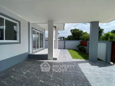 Spacious modern patio with elegant tile flooring and garden view
