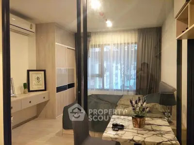 Modern bedroom with stylish decor and large window, featuring a cozy bed and elegant furnishings.