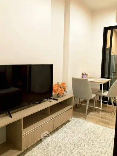 Cozy living room with modern TV stand and dining area, perfect for urban living.