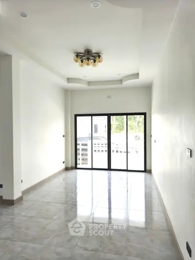 Spacious and bright living room with modern ceiling light and large windows