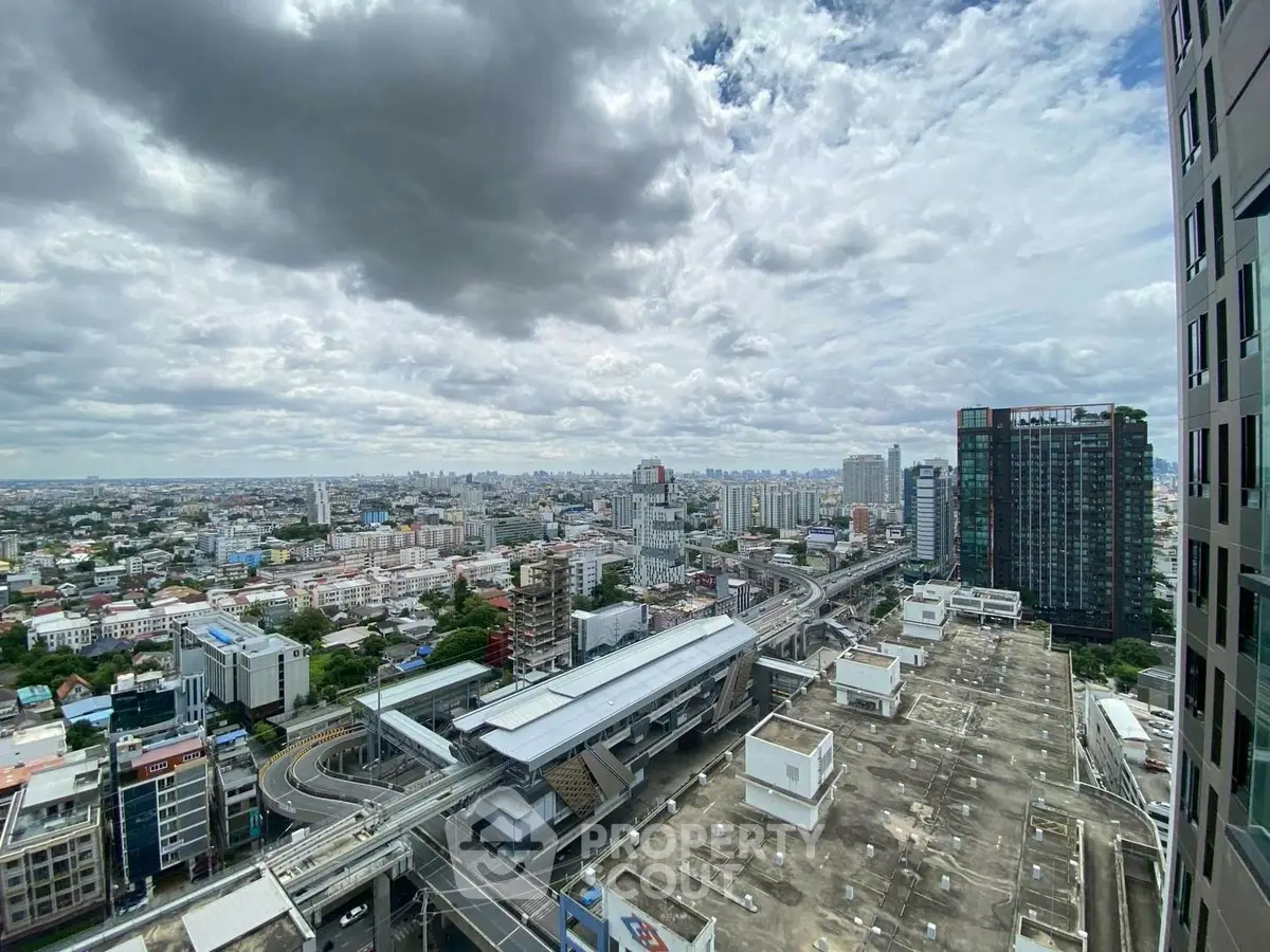 Stunning cityscape view from high-rise building showcasing urban skyline and transportation hub.