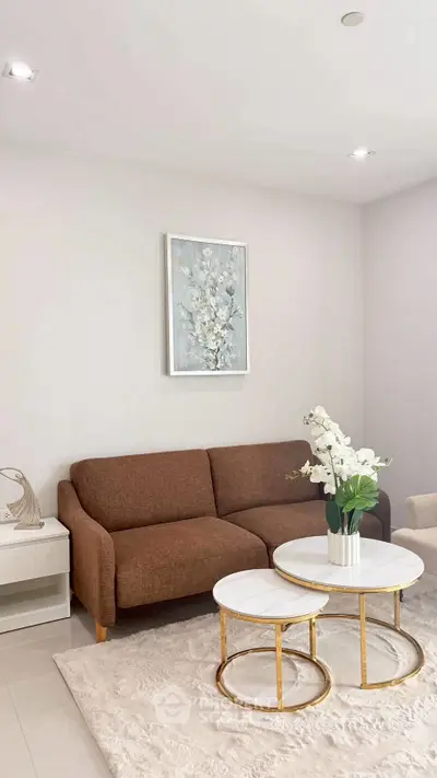 Elegant living room with modern brown sofa, chic coffee tables, and stylish decor in a cozy setting.