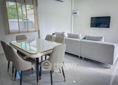 Modern living room with elegant dining area and stylish furniture