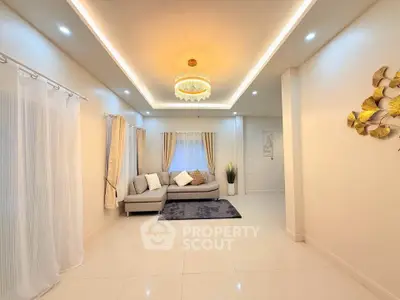 Elegant living room with modern lighting and cozy sofa in a bright, spacious interior.