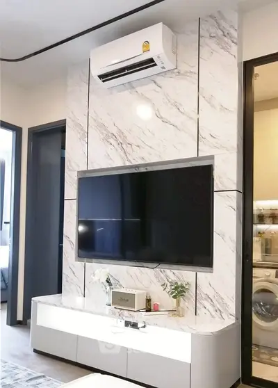 Modern living room with marble TV wall and air conditioning